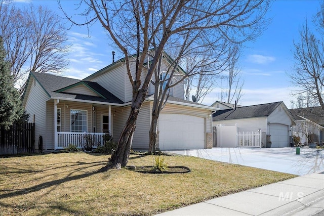 traditional-style house with a garage, covered porch, fence, and a front yard