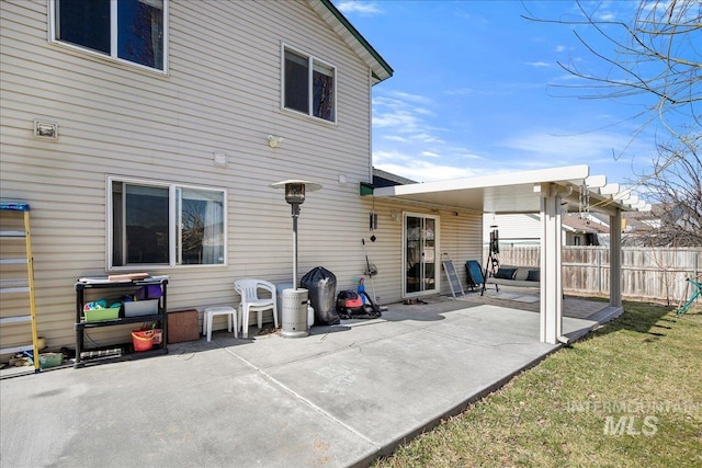 back of property featuring a patio area and fence