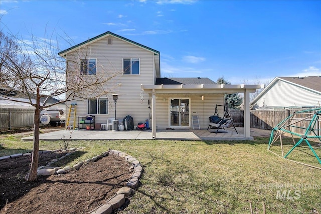 back of house featuring a patio area, a fenced backyard, and a yard