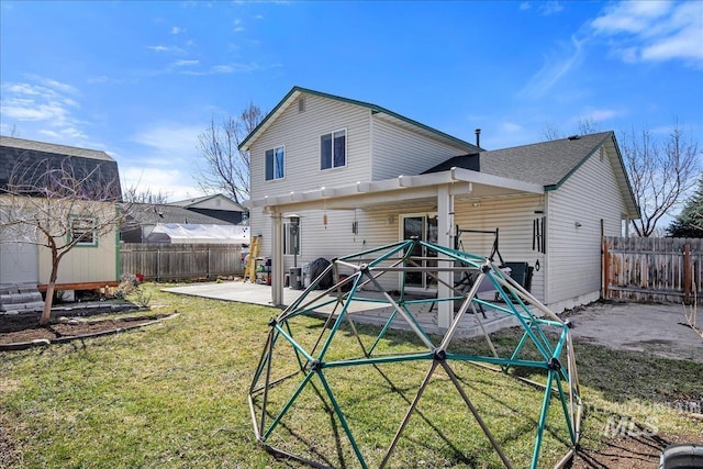 back of property featuring a patio, a lawn, and a fenced backyard