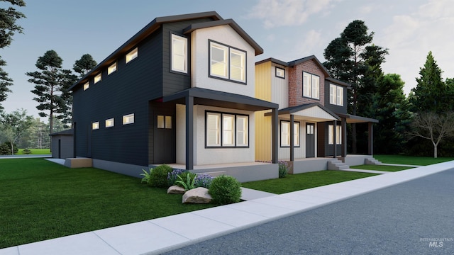 modern home featuring a front lawn and a porch