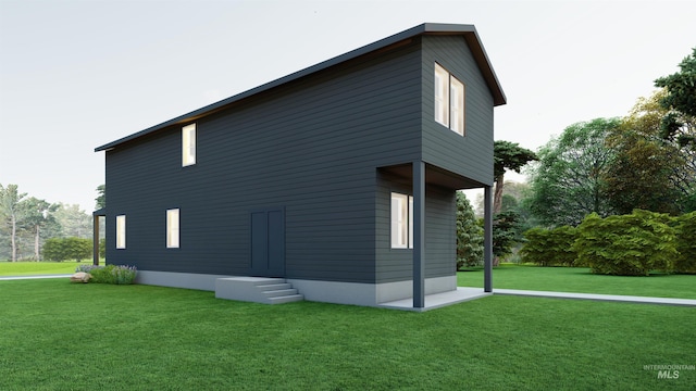 view of side of property with entry steps and a lawn