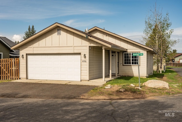 406 Margaret Way, Mccall, ID 83638 - ranch-style house featuring a garage, asphalt driveway, and board and batten siding