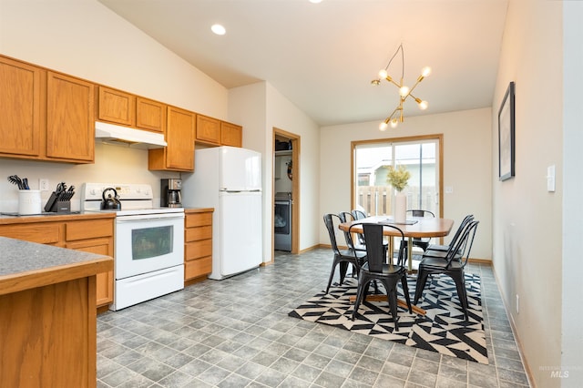 406 Margaret Way, Mccall, ID 83638 - kitchen featuring white appliances, under cabinet range hood, vaulted ceiling, washer / clothes dryer, and a chandelier