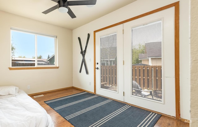 406 Margaret Way, Mccall, ID 83638 - bedroom with access to exterior, wood finished floors, baseboards, and a ceiling fan