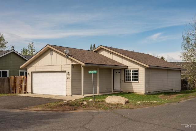 406 Margaret Way, Mccall, ID 83638 - single story home featuring a garage, asphalt driveway, board and batten siding, and a shingled roof