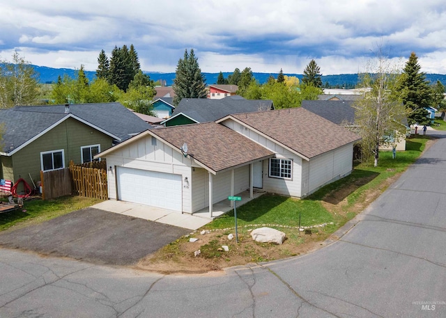406 Margaret Way, Mccall, ID 83638 - view of front of house featuring a shingled roof, an attached garage, asphalt driveway, and board and batten siding