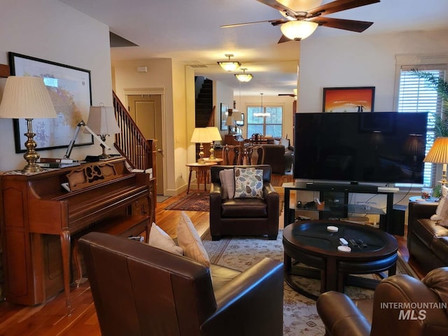 living room featuring dark hardwood / wood-style flooring and ceiling fan