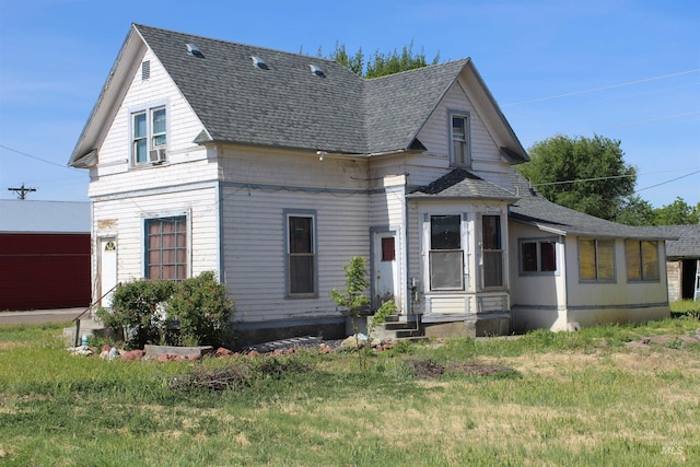 back of property featuring a lawn