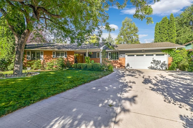 ranch-style home featuring a garage and a front yard