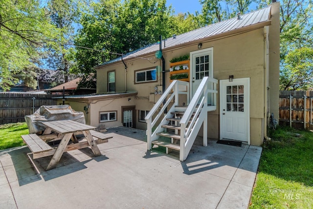 back of property with a patio area