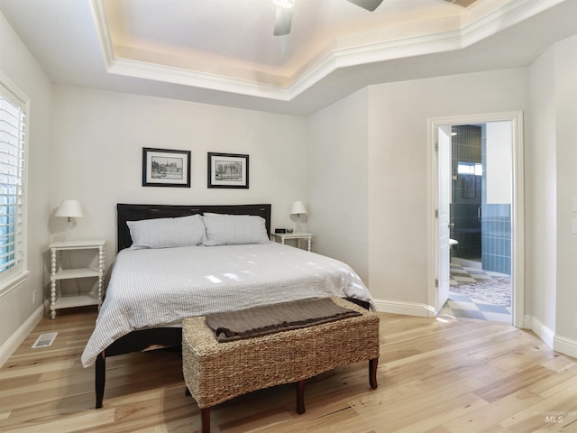 1262 N Forestdale Pl, Eagle, ID 83616 - bedroom featuring a raised ceiling, light wood-style flooring, ornamental molding, ensuite bath, and a ceiling fan