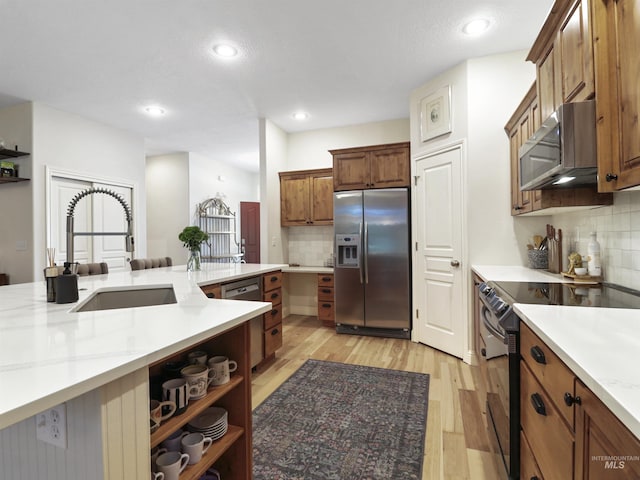 1262 N Forestdale Pl, Eagle, ID 83616 - kitchen featuring stainless steel appliances, tasteful backsplash, light wood finished floors, recessed lighting, and brown cabinets