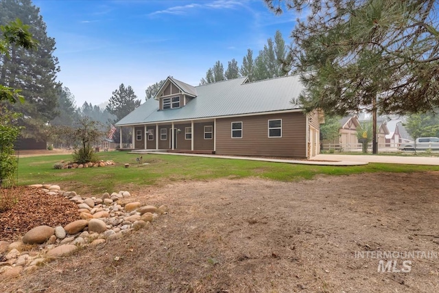 back of house with a lawn