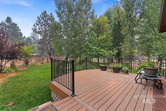 wooden deck with a lawn