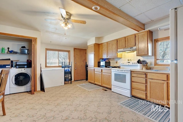 4661 Idaho St, New Plymouth, ID 83655 - kitchen featuring electric range, under cabinet range hood, washer / dryer, and plenty of natural light