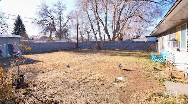 view of yard with a fenced backyard and cooling unit