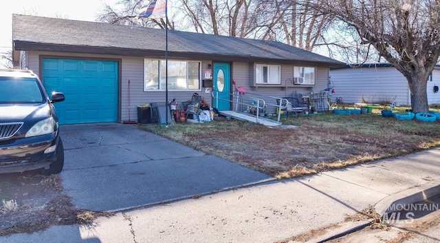 single story home with a garage, concrete driveway, and roof with shingles