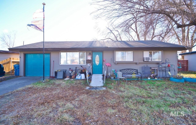 ranch-style home with an attached garage, driveway, fence, and cooling unit