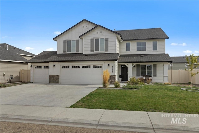 view of front property featuring a garage and a front lawn