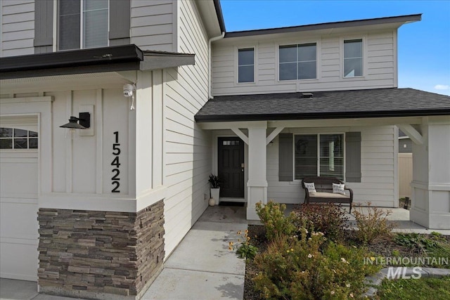 view of exterior entry with covered porch