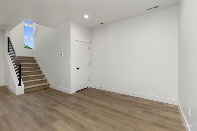 spare room with wood-type flooring