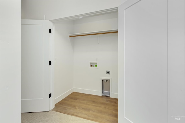 clothes washing area with hookup for an electric dryer, light wood-type flooring, and washer hookup