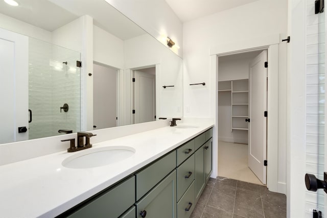 bathroom with a shower with door and vanity