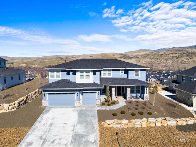 view of front of property with a porch, a mountain view, an attached garage, concrete driveway, and a residential view