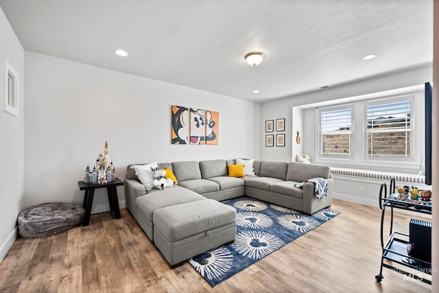 living room with recessed lighting, wood finished floors, and baseboards