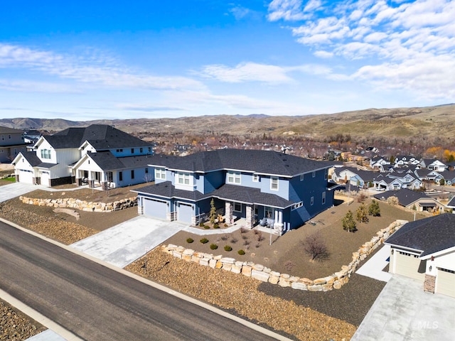 birds eye view of property with a residential view and a mountain view