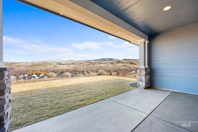 view of patio / terrace featuring a mountain view