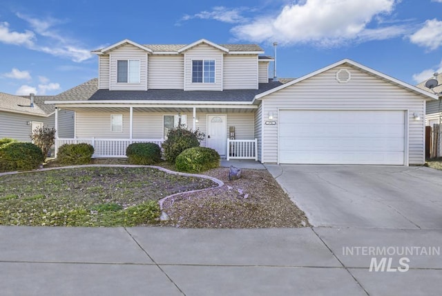 view of property featuring a garage and covered porch