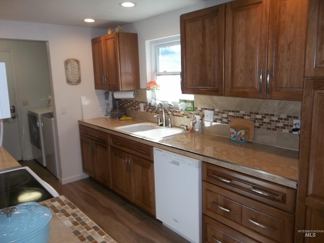 kitchen featuring white dishwasher, sink, decorative backsplash, and dark wood-type flooring