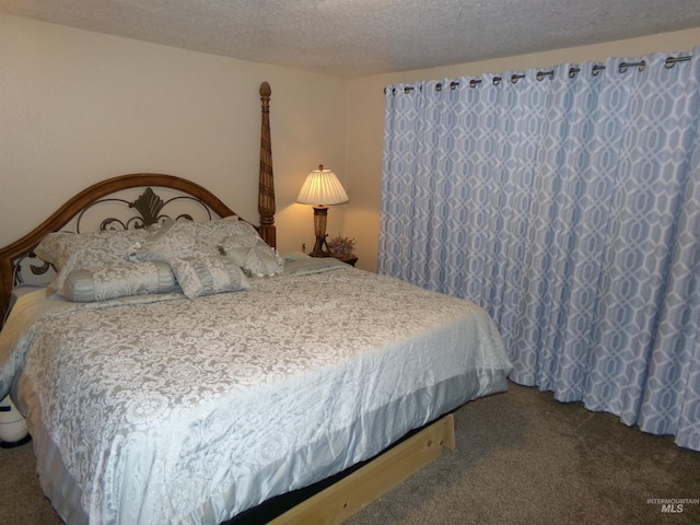 bedroom with carpet flooring and a textured ceiling