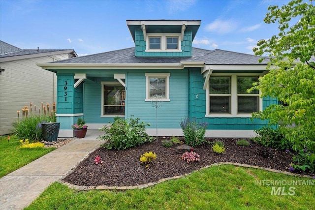 3931 N Park Crossing Ave, Meridian, ID 83646 - view of front facade featuring roof with shingles, covered porch, and a front yard