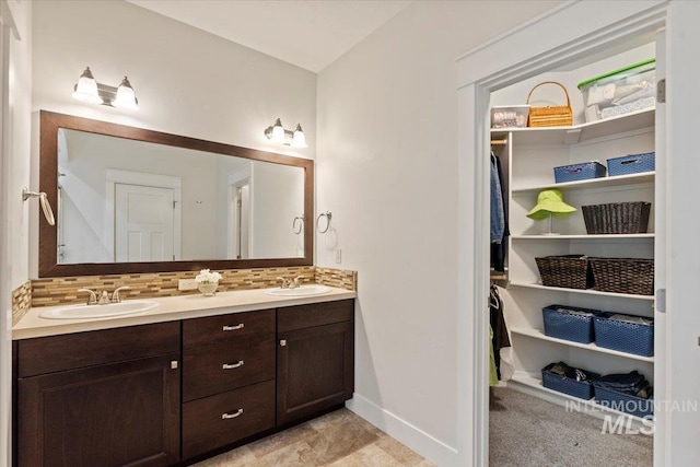 3931 N Park Crossing Ave, Meridian, ID 83646 - bathroom featuring double vanity, a closet, and tasteful backsplash