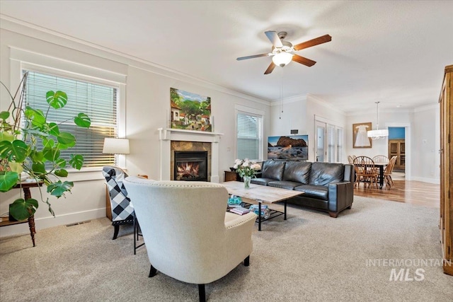3931 N Park Crossing Ave, Meridian, ID 83646 - living area featuring light carpet, a ceiling fan, crown molding, and a tiled fireplace