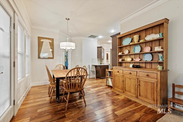 3931 N Park Crossing Ave, Meridian, ID 83646 - dining area with light wood-style flooring, ornamental molding, a chandelier, and recessed lighting