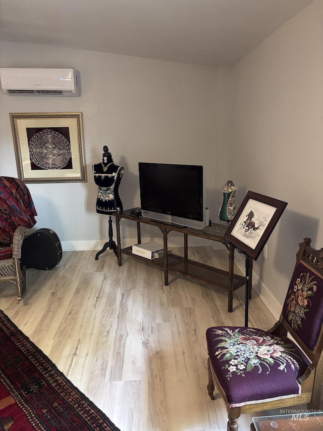 907 Prospect Ave, Lewiston, ID 83501 - sitting room featuring a wall unit AC and wood finished floors