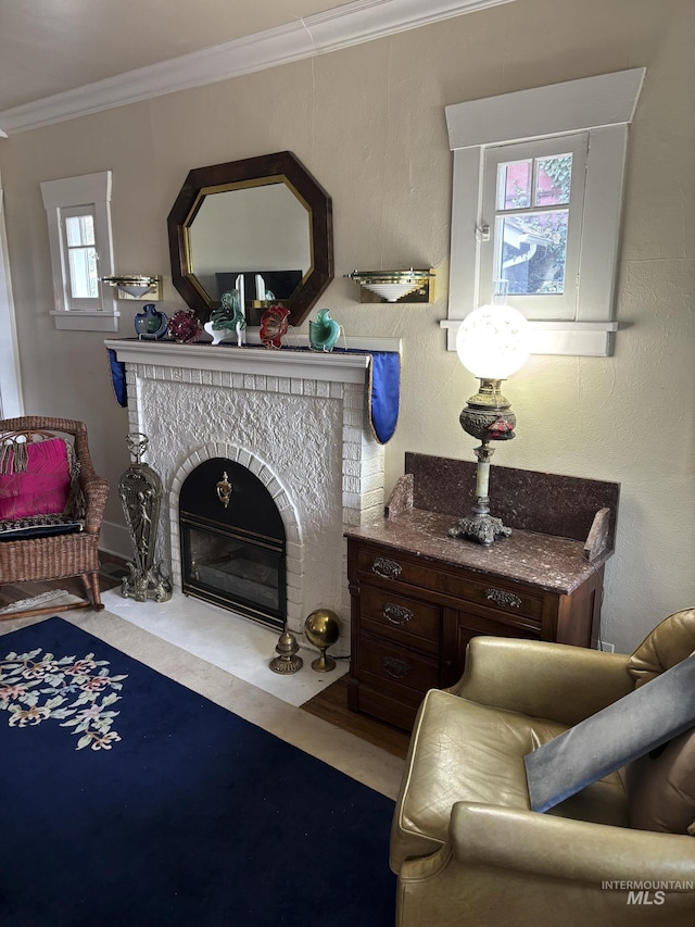 907 Prospect Ave, Lewiston, ID 83501 - living area featuring plenty of natural light, ornamental molding, a fireplace with flush hearth, and wood finished floors