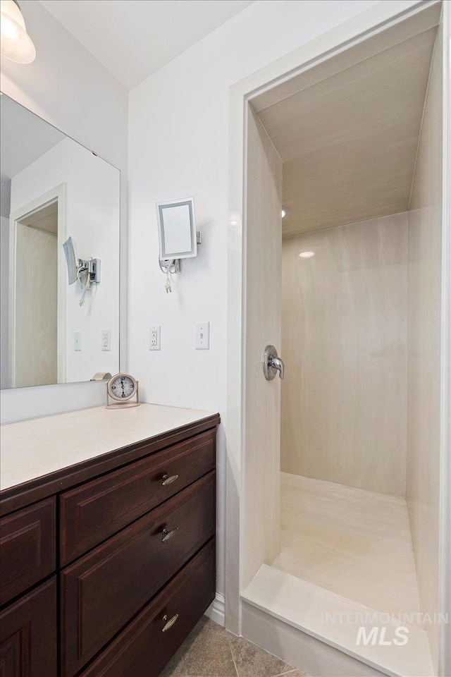 bathroom featuring walk in shower and vanity