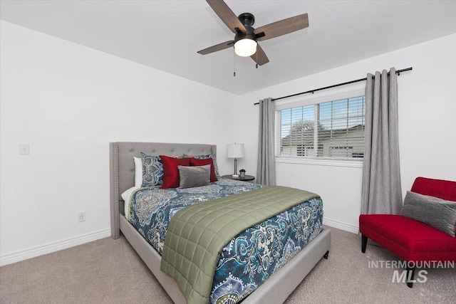 carpeted bedroom with baseboards and a ceiling fan