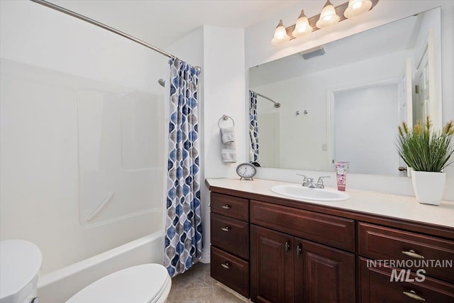 bathroom featuring shower / bath combination with curtain, vanity, toilet, and tile patterned floors