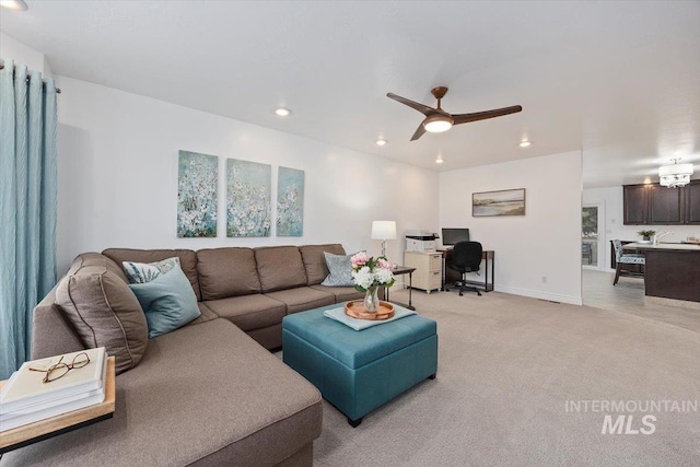 living area with a ceiling fan, recessed lighting, light colored carpet, and baseboards