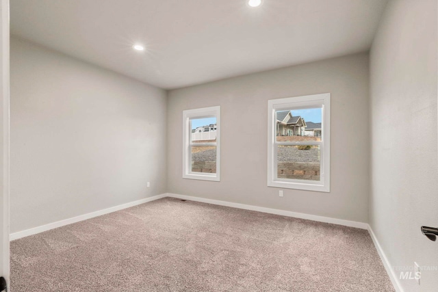 spare room with carpet and plenty of natural light