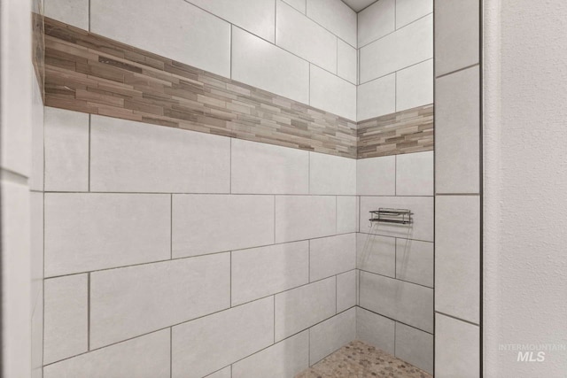 bathroom with tiled shower