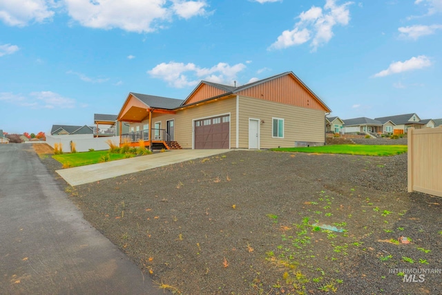 view of front of house with a porch, a front lawn, and a garage