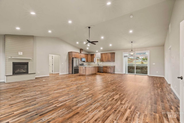 unfurnished living room featuring light hardwood / wood-style flooring, a fireplace, high vaulted ceiling, and ceiling fan