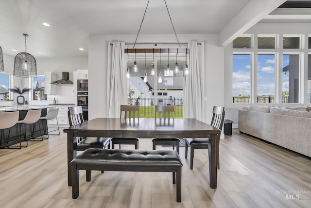 dining space with recessed lighting and light wood finished floors